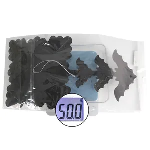 Measurement of Halloween black hanging decorations weighing exactly 50.0g in packaging