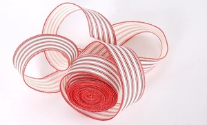 Close-up of red and white striped Christmas ribbon with fine stitched edge detailing