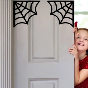 Close-up of Halloween black spider web corner decor on a white door frame with a child