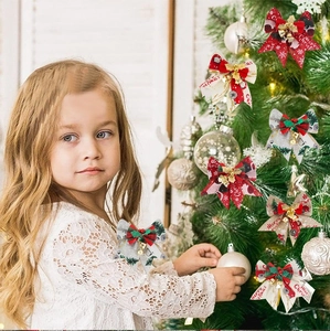 Detailed view of Christmas bows with bells and snowflake prints on a decorated Xmas tree