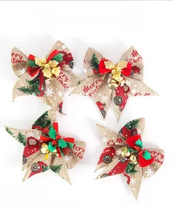 Set of four rustic burlap Christmas bows with festive prints and golden bell details