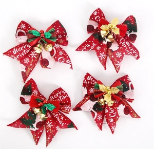 Detailed view of red Merry Christmas bows with golden bells and festive holiday prints