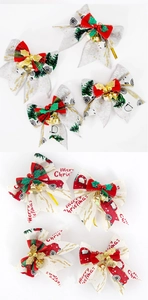 Detail of burlap Christmas bows with festive truck prints, golden bells and red berries