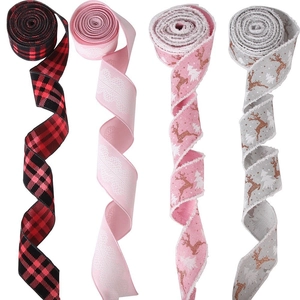 Vertical spiral Christmas ribbons with deer prints and festive plaid patterns on white background