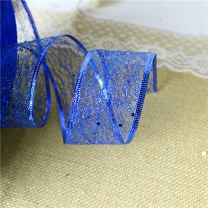 Close-up of royal blue mesh ribbon with sequins and edge stitching on burlap