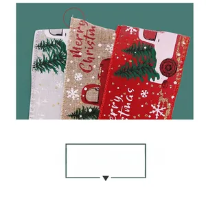 Detail of Christmas ribbons with truck and tree patterns in red, khaki, and grey linen