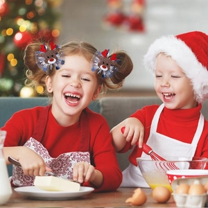 Close-up of reindeer hair clips with red antlers and sequins worn by kids at Christmas