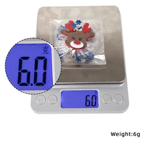 Detailed view of lightweight Christmas reindeer antler hair clip on weight scale