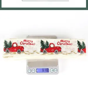 Detail showing Christmas ribbon weight of 61.0g and 14.5cm width on electronic scale