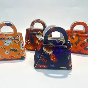 Detail of felt Halloween candy bags with ghost, pumpkin, and spider patterns for party favors