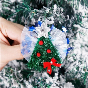 Macro detail of Christmas tree hair clip with tulle bow and glitter star decoration