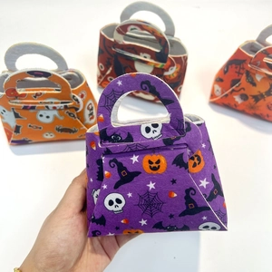 Detail of Halloween felt candy bags featuring pumpkin, skull and bat patterns with handles