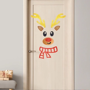 Close-up of glitter reindeer wall stickers with gold antlers and red scarf on a door