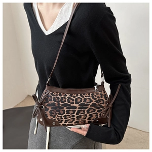 Close-up of leopard print shoulder bag with brown trim and stylish bow knot details