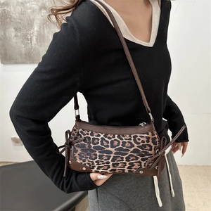Chic leopard print shoulder bag with bow accents and zip closure for women