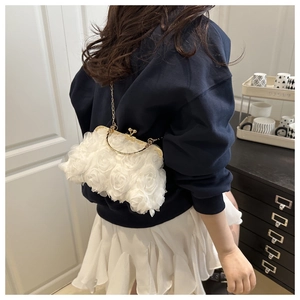 Detail of white 3D mesh rose handbag with vintage gold metal frame and chain strap