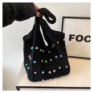 Detail of black crochet tote bag featuring multi-colored faux pearls and woven texture