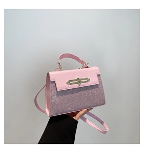 Detailed view of the pink glitter patchwork crossbody bag with a gold metal lock closure
