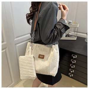 Detail of cream corduroy tote bag with chain strap and matching small pouch