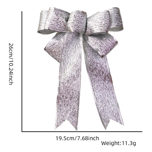 Glittery silver Christmas bow ornament showing dimensions 26cm length and 19.5cm width
