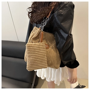 Detail of khaki corduroy tote bag with small pouch and metal chain leather strap