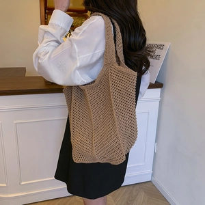 Brown woven crochet tote bag with large mesh design for summer vacation use