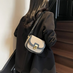 Classic cream canvas saddle bag with leather trim and gold buckle for women