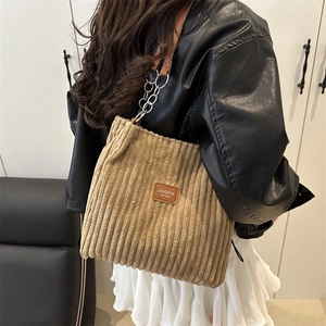 Brown corduroy shoulder bag with metal chain strap and vintage leather label detail