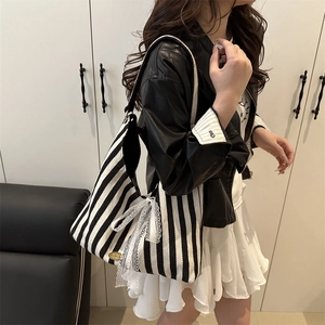 Vertical striped canvas tote bag with white lace bows and elegant half-moon design
