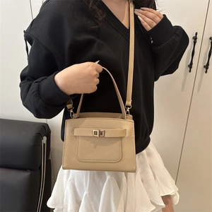 Minimalist beige crossbody tote bag for women with gold twist lock and top handle