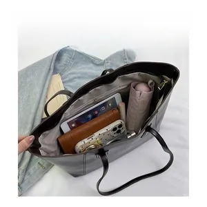 Deep brown tote bag showing large capacity storage for tablet, wallet, and umbrella