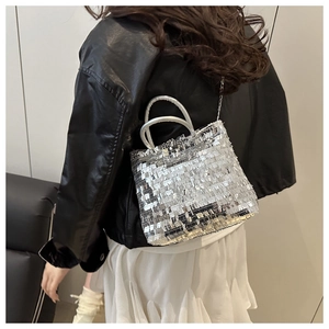 Silver sequin tote bag showing detailed metallic finish and elegant hand-carry style