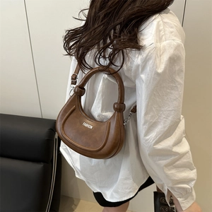 Brown PU leather crescent shoulder bag with adjustable strap and Fashion text logo