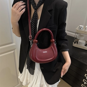Chic burgundy crescent shoulder bag in leather with fashion logo and top handle