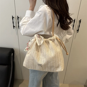 Minimalist beige straw tote bag with floral lace scarf and long leather straps