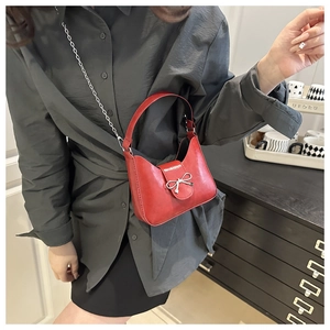Détail du sac demi-lune rouge avec boucle noeud argentée et bandoulière chaîne