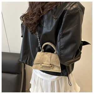 Detailed back view of a khaki mini trapezoid handbag with silver chain and metal ring