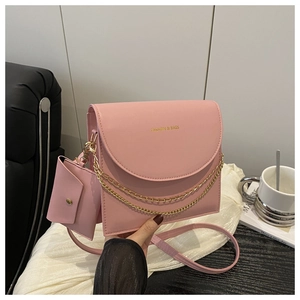 Pink PU leather crossbody bag set with gold chain detail and small charm pouch