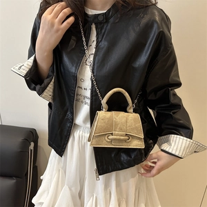 Chic khaki suede crossbody bag with silver chain strap shown as a handheld satchel