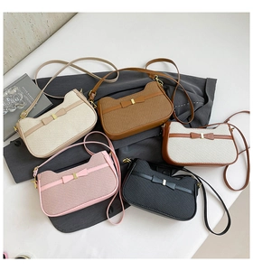 Detailed macro view of woven texture small square bags with bow knot and metal buckle
