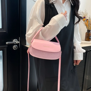 Pink minimalist crossbody flap bag with adjustable strap and metallic texture finish