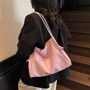 Minimalist light pink leather tote bag for women with knot detail on shoulder strap