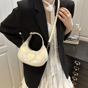Chic white crescent underarm bag with lace heart detail and detachable shoulder strap