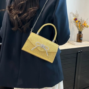Sac bandoulière pailleté doré chic avec nœud en strass et chaîne argentée pour soirées