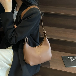 Caramel brown leather hobo shoulder bag with adjustable strap and minimalist design