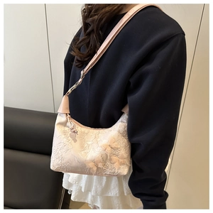 Detail of pink lace bucket bag featuring delicate 3D mesh butterfly and floral embroidery