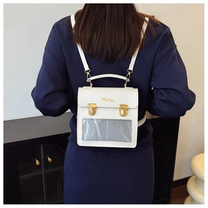 Close-up of white leather backpack with transparent mesh window and gold buckles