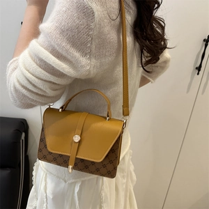 Fashionable ginger yellow and brown patterned small crossbody bag with gold buckle detail