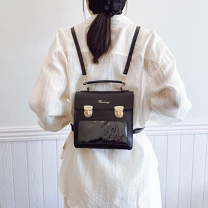 Minimalist black PU leather backpack with clear PVC window and gold snap button for women