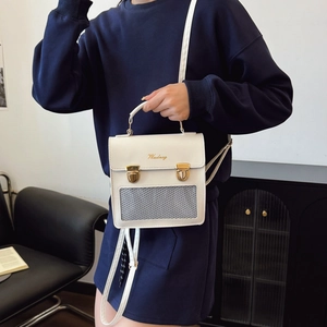 White leather backpack with grey mesh pocket and gold hardware shown in a lifestyle setting